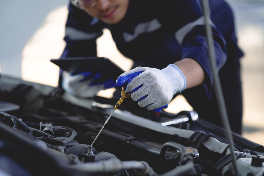 Auto,Mechanic,Is,Working,On,Car,Engine,In,Mechanic,Shop. Auto,Mechanic,Is,Working,On,Car,Engine,In,Mechanic,Shop.